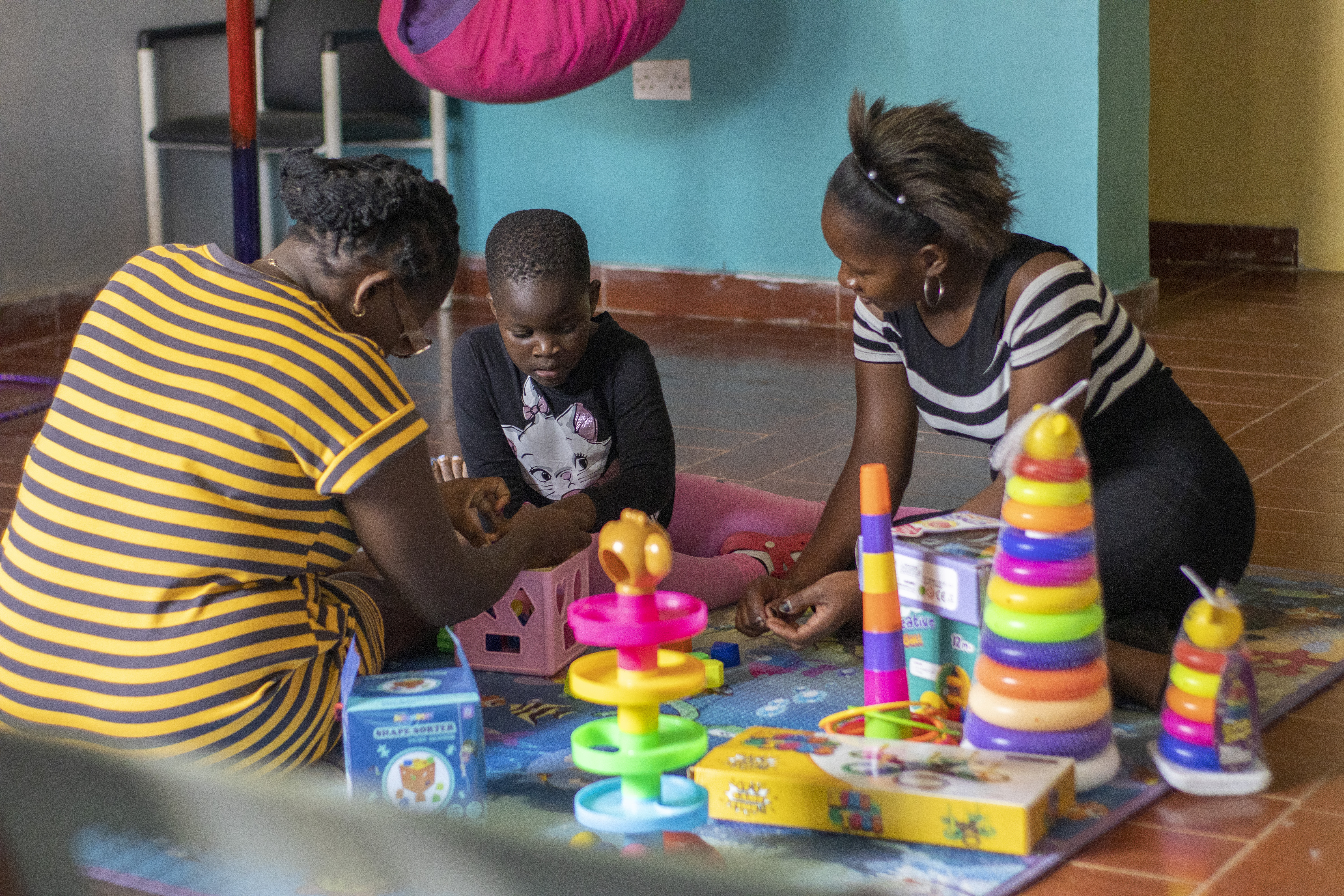 Children playing with educational toys and stacking rings